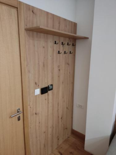 a room with a wooden door with a shelf at Apartments D035 & D032 in Aparthotel Vucko, Jahorina-private host in Jahorina