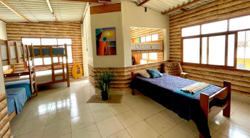 a bedroom with a bed in a room with wooden walls at Capitan Brau's in Los Órganos