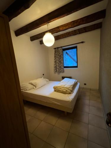 a bedroom with a bed and a window at Le Bouffadou in Peisey-Nancroix
