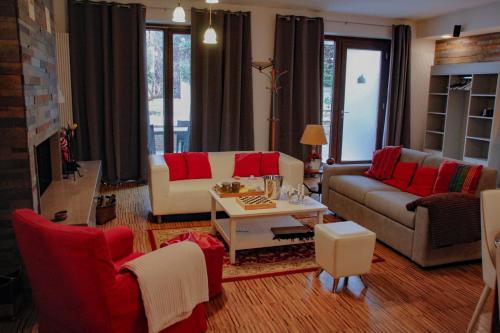 a living room with couches and red pillows at VillaTonia - Suite home in Molfetta
