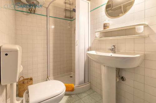 a bathroom with a toilet and a sink and a shower at Carlo Alberto Apartment, Alghero old town, near the beach in Alghero