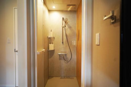 a bathroom with a shower with a toilet in it at Etcetera Niijima Nagisa Building - Vacation STAY 02083v in Niijimamura