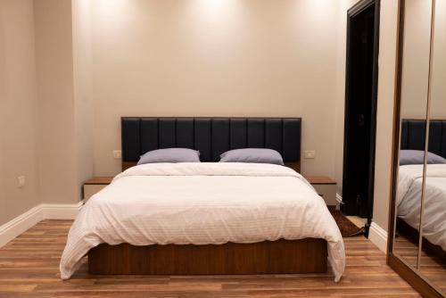 a bedroom with a large bed and a large mirror at Munir’s residence in Cairo