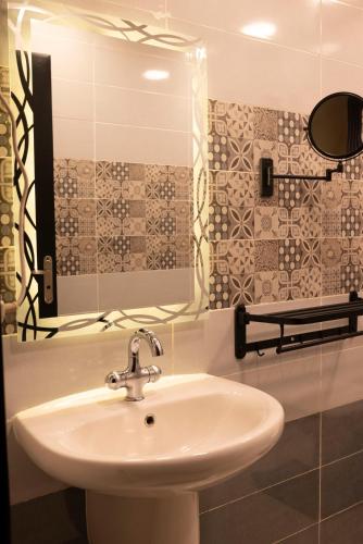 a bathroom with a sink and a mirror at Munir’s residence in Cairo