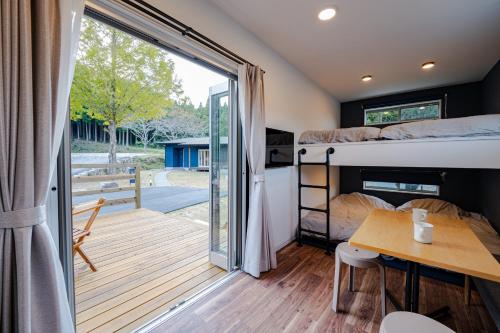 Cette chambre dispose de lits superposés, d'une table et d'un balcon. dans l'établissement Class Besso Ise - Vacation STAY 61656v, à Iseji