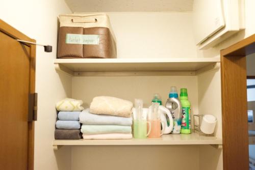 a shelf with towels and other items in a bathroom at Rose Park Nibankan - Vacation STAY 71056v in Funabashi