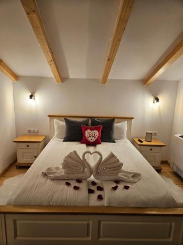 a bedroom with a large bed with two mitts on it at Casa Mara Viseu de Sus in Vişeu de Sus