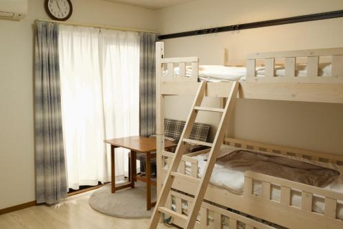 a room with two bunk beds and a desk at Rose Park Nibankan - Vacation STAY 71056v in Funabashi