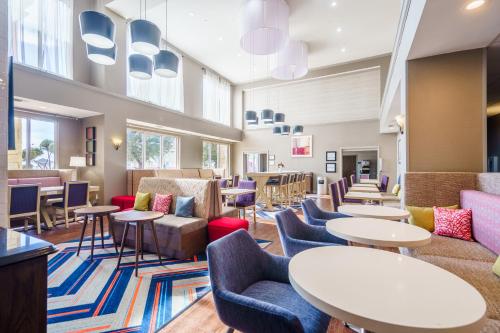 a waiting room with tables and chairs at Hampton Inn & Suites Abilene I-20 in Abilene