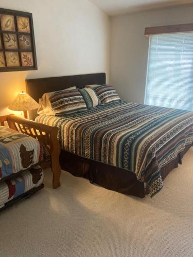 a bedroom with a bed and a lamp and a window at 5123 Summit View Court in Somerset
