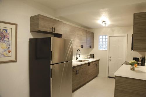 a kitchen with a stainless steel refrigerator and a sink at Apt 5 Miami Designer Apartment in the Upper East-Side in Miami