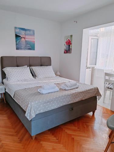 a bedroom with a bed with two towels on it at Studio Bobo in Rovinj