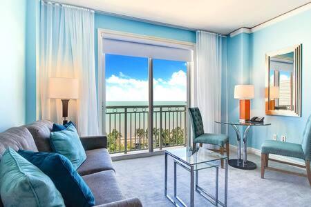 a living room with a couch and a view of the ocean at The Palms, Ocean View Studio Located at Ritz Carlton - Key Biscayne in Miami