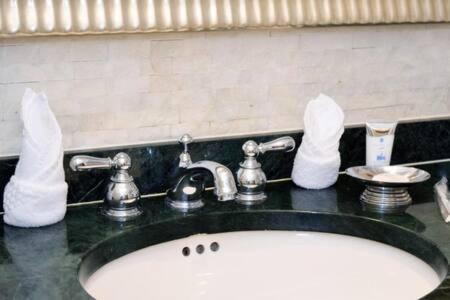 a bathroom sink with towels on top of it at The Palms, Ocean View Studio Located at Ritz Carlton - Key Biscayne in Miami