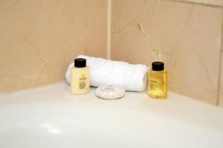 two bottles of soap and a roll of toilet paper at The Palms, Ocean View Studio Located at Ritz Carlton - Key Biscayne in Miami