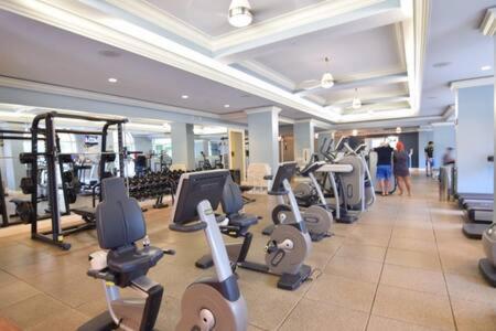 a gym with a row of treadmills and machines at The Palms, Ocean View Studio Located at Ritz Carlton - Key Biscayne in Miami