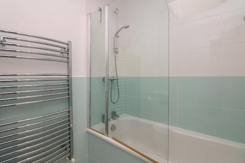 a bathroom with a shower and a glass shower stall at 2 Dart in Stoke Gabriel