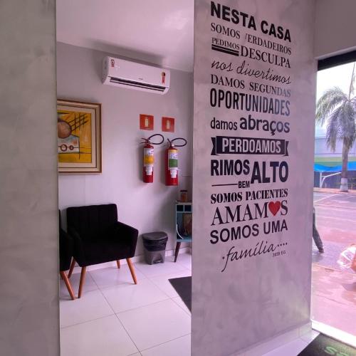 a wall with words on it in a room at Hotel dos viajantes in Sorriso