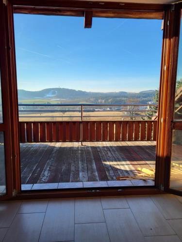 a view from a large glass window of a balcony at Apartmán Holubka in Nové Město na Moravě