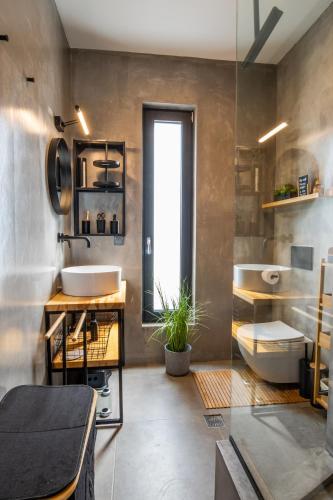 a bathroom with a sink and a tub and a toilet at Villa Pleiades in Karpathos