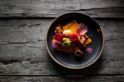 a plate of food on a wooden table at Hotel-Restaurant-Café Krainer in Langenwang