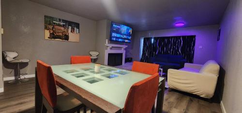 a dining room with a table and chairs and a living room at Large Condo in the heart of Las Colinas, near Dallas in Irving
