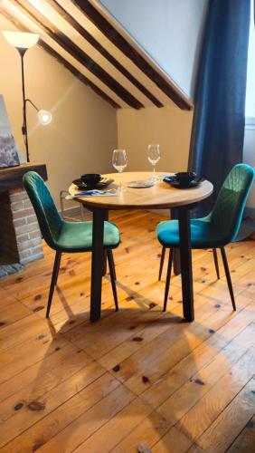 a wooden table with chairs and wine glasses on it at Dames de Montmartre in Paris