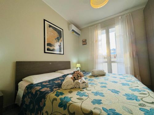 a bedroom with a bed with a teddy bear on it at Casa vacanza "Orchidea" in Marzamemi