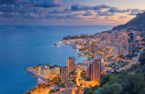 an aerial view of the city ofania at night at MONACO # MENTON - NEW - 6 PERSONS - 2 BEDROOMS - PARKING - CLIM - PREMIUM - Beach and Sun in Menton