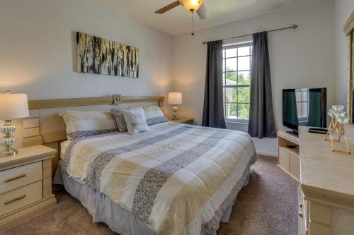 a bedroom with a bed and a flat screen tv at Butterfly Palm at Ellis Exclusive Villas in Kissimmee