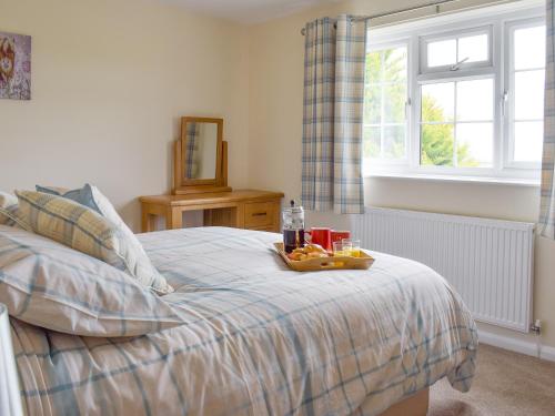 a bedroom with a bed with a tray of food on it at Rudda Farm House - Uk2491 in Staintondale