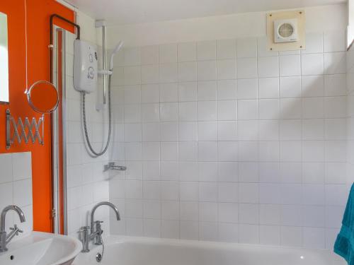a bathroom with a tub and a sink and a shower at Hollybush Studio - Uk39054 in Knebworth