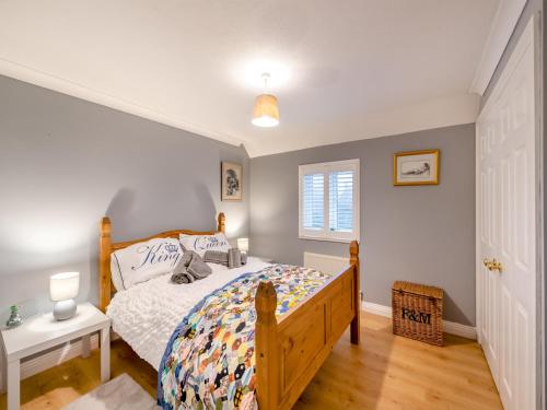 a bedroom with a bed with a wooden bed frame at The Roddy House in West Bay