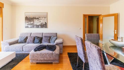 a living room with a couch and chairs at Central Matosinhos Apartment by Unique Hosts in Senhora da Hora
