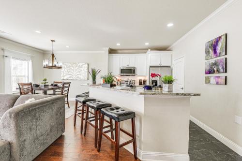a kitchen and living room with a bar and a couch at Family-Friendly FIFA World Cup Home Base! in Grand Prairie