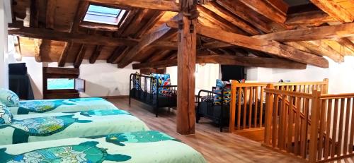 two beds in a room with wooden ceilings at Izarrate 