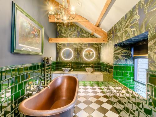 baño con paredes de azulejos verdes y bañera en 8 Bed in Allendale 90713, en Catton