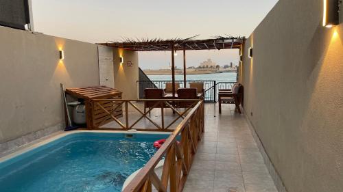 a swimming pool with a view of the water at درة العروس فيلا بشاطئ رملي خاص in Durat  Alarous