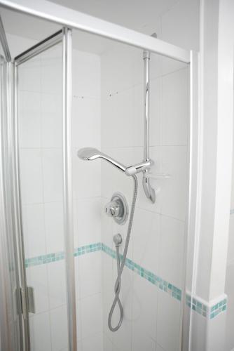 a shower with a glass door in a bathroom at Stylish Pride Park DERBY Apartment - Free Netflix, WIFI, Parking in Derby