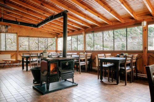 a wood stove in a restaurant with tables and chairs at Bagdat Resort in Yalova