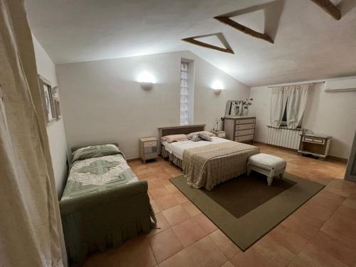 a bedroom with a bed and a couch in it at Un 'Oasi nel verde ad un passo da tutto in San Felice a Cancello