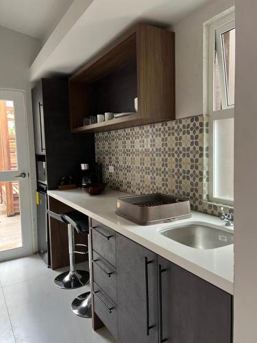 a kitchen with a sink and a counter top at Subtropica Premium Suites - Mindo in Mindo