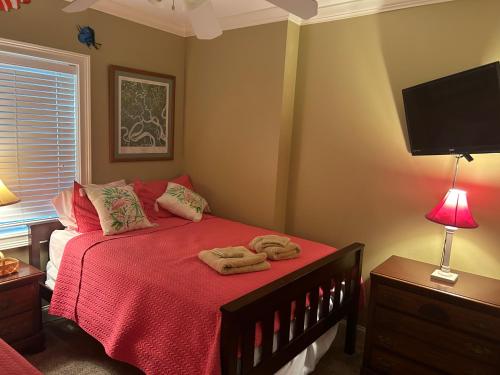 a bedroom with a bed with two towels on it at Unique 3BR, 1 of 5 Condos w/Huge Poolside Patio, Steps to Beach & Pier, Gated in Tybee Island