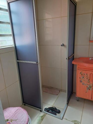 a shower with a glass door in a bathroom at Casa do Mato I in São Lourenço do Sul