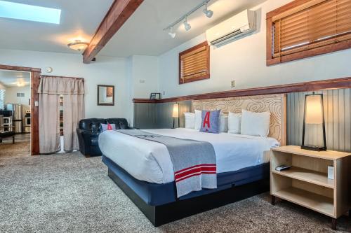 una camera d'albergo con un letto grande e una sedia di A-Lodge Boulder a Boulder