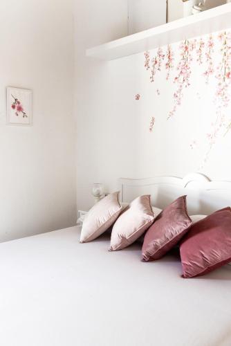 a row of pillows sitting on a bed at Love Nests by The Bell Tower Lodge in Palidoro