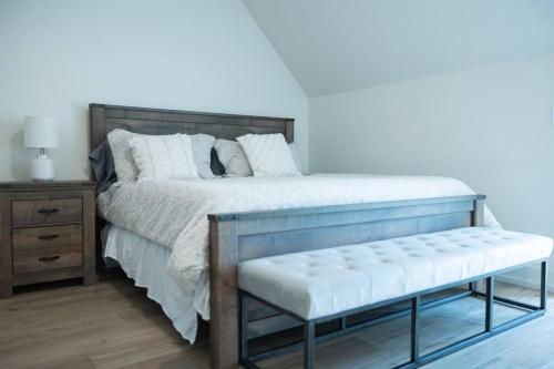 a bedroom with a bed with a bench in it at New Modern Style Townhome in Sevierville
