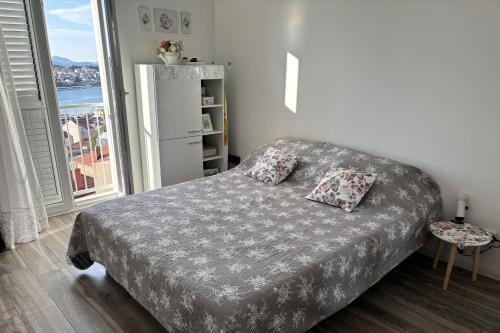 a bedroom with a bed with two pillows on it at APARTMENT ROLEX -near the port Dubrovnik in Dubrovnik