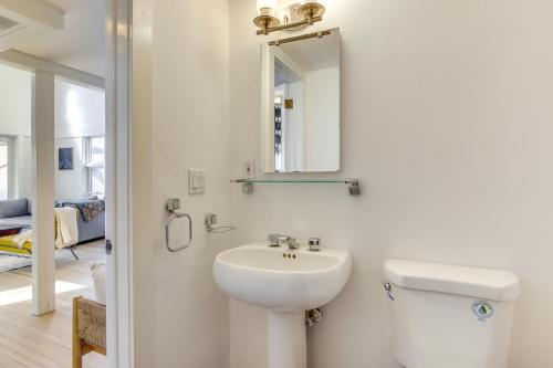 Baño blanco con lavabo y espejo en Dreamy Hudson Valley Cottage with State Park Views, en Garrison