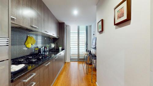 a kitchen with wooden cabinets and a counter top at Happy Building By GW Holidays in Lisbon